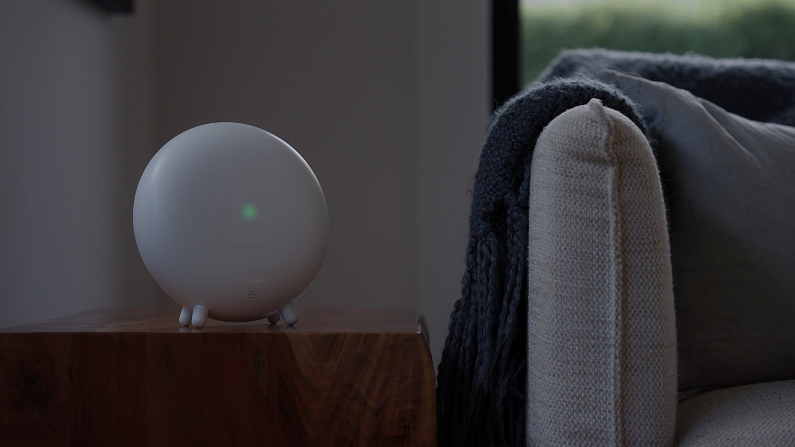 The Indoor Halo on a side table beside a sofa